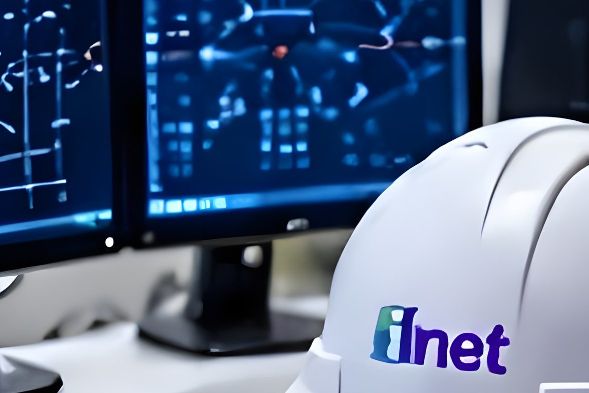 Engineer's safety helmet with the iNet logo in a network operations environment
